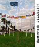 Small photo of SALOU, SPAIN - October 14, 2019 The European Union (EU) fag surrounded by European flags against a background filed with a blue sky and palm trees.