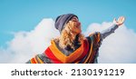 Small photo of Overjoed adult woman outstretching arms with happy posture. Life balance and happiness for joyful female people smiling and closing eyes against a sunny blue sky. Tourist and travel concept