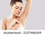 Small photo of Armpit epilation, lacer hair removal. Young woman holding her arms up and showing clean underarms, depilation smooth clear skin.