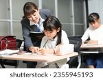 Small photo of Image of a female student studying and a cram school instructor