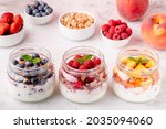 Healthy breakfast. Granola  muesli yoghurt and fruit served in glass jars.
