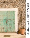 Small photo of Cyan colored door of a small house in the salt town of Sa Canal on the island of Ibiza.