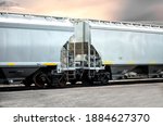 Small photo of Two hopper style railcars on railroad track.