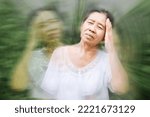 Small photo of old elderly Asian feeling faint and dizzy from hot weather