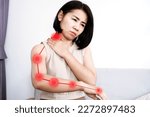 Small photo of Asian woman suffering from nerve and muscle pain in neck and shoulder radiating down arm, Cervical Radiculopathy concept