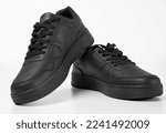 Black shoes isolated on white background. A pair of black sneakers.