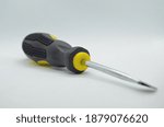 screwdriver, close up photo of black-yellow screwdriver on isolated white background