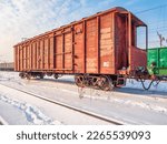 Small photo of Red old, worn out boxcar of standard design on the rails on Trans-Siberian Railway.