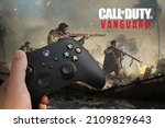 Small photo of Man holding a Xbox Series S Carbon Black Controller with Call of Duty Vanguard game blurred in the background. Rio de Janeiro, RJ, Brazil. December 2021.