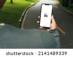 Small photo of Girl in the park holding a smartphone with Nike Training Club NTC app on the screen. Rio de Janeiro, RJ, Brazil. March 2022.