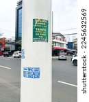 Small photo of Jakarta, Indonesia - December 20, 2022 : a street lamp post with posters affixed to suck up toilets on the side of the road