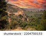 Small photo of The Kasbah castle from the Middle Atlas and the Tadla plain of Morocco protecting and overlooking the Moroccan city of Beni Mellal-Jenifra under an orange sky. Concept Morocco, castle, city, landscape