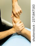 Small photo of Vertical photo of an unrecognizable physiotherapist or podiatrist examines the foot of a patient suffering from a bunion in a modern clinic. Massages in bunions. Hallux Valgus