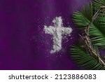 Small photo of Lent border of cross of ashes, palm leaves and crown of thorns on a dark purple background