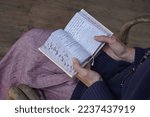 Small photo of Woman holds a siddur (jewish prayer book) in her hands while praying. Jerusalem, Israel, april 2022 (54)