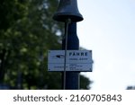 Small photo of Close-up of bell of ferry named Vogel Gryff with time table sign at City of Basel on a sunny spring day