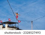 Small photo of Fun fair named Zuri Fascht at City of Zurich with male funambulist up in the air on a sunny summer evening