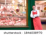 A Young Smiling Butcher In Red...