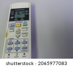 Small photo of Air conditioner remote control over white background with negatif space.