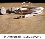 white earphones placed on the table