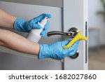 Small photo of Cleaning door handles with an antiseptic during a viral epidemic