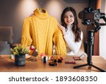 Beauty blogger sweet female filming daily make-up routine tutorial on camera. Influencer young woman live streaming cosmetics product review in home studio. Vlogger job. Showing clothes. Lookbook.