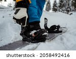 Small photo of Men's boots and snowboard freerider in mountains. Winter sport, leisure outdoor lifestyle