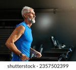 Portrait of a senior man exercising in a gym, mature male running using treadmill machine equipment, healthy lifestyle and cardio exercise at fitness club concepts, vitality and active training coach 