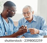 Small photo of Doctor or nurse caregiver showing a prescrption or documents and holding drug bottle to senior man at home or nursing home