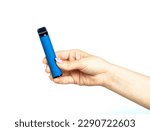 Small photo of Female hand holds electronic cigarette on a white background. Disposable electronic cigarette. concept of modern smoking, vaping and nicotine. copyspace. Alternative way of smoking vaping device