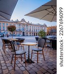 Small photo of Toulouse, France - May 27th 2021: Chairs, tables and sunshade of a cafe terrace on the Capitole square in Toulouse in the south of France (Haute Garonne)
