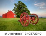 Cannon at Saratoga National Battlefield with Neilson Farm in the background. 
