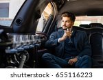 Business man in limousine with glass of champagne, enjoying