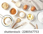 Baking pastry or cake ingredients, sugar, flour, eggs and milk with notebook and pen on marble table, top view