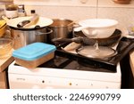 Small photo of Huge heap of dirty dishes waiting for the flatmate in the kitchen