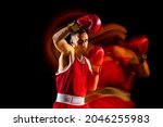 Small photo of Ready to knock down the opponent . Punching. One professional male boxer training isolated over black backgrund in mixed light. Concept of health, sport, motion, strength. Copy space for ad.