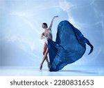 Small photo of Aesthetic of classical dance. One adorable ballerina wearing beige bodysuits emotional dancing with fabric silk. Concept of classic ballet, inspiration, beauty, dance, creativity