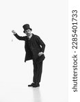 Small photo of Day scheduled in minutes. Black and white portrait of retro gentleman wearing vintage suit and holding pocket watch. Concept of english culture, comparison eras, vintage, retro