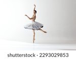 Tender soul. Portrait of young ballerina dancing, performing isolated over white studio background. Beauty of classical dance. Concept of classic ballet, inspiration, beauty, dance, creativity