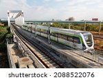Small photo of A metro train of Taichung MRT (Mass Rapid Transit) dashing through a bridge near the High Speed Rail Station on a beautiful sunny day, in Wuri District, Taichung City, Taiwan