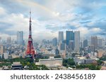 Beautiful city skyline of Downtown Tokyo, with the famous landmark Tokyo Tower standing out amid the crowded skyscrapers under rainbow sky and Zojoji Temple 增上寺 located in the nearby Shiba Koen Park