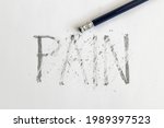 Small photo of Erasing pain. Pain written on white paper with a pencil, erased with an eraser. Symbolic for overcoming pain or treating pain.