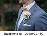 Groom wearing a beautiful boutonniere close-up