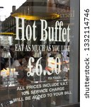 Small photo of LONDON, UK - JUNE 2012: Window of a restaurant in front of a theatre in Soho with hot buffet and price for the formula eat as much as you like.