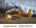 Small photo of 19.02.2023 janowice poland, health emergency medical servce helicopter, hems flying back to base. he is starting up. Front light is turned on until start