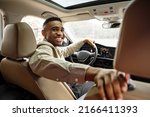 Joyful African American Man Smiling Sitting In Automobile Looking Back At Camera