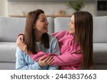 Teen girl hugging mother and...