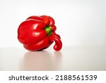 Ugly veggie red bell pepper on the whitetable with white background