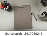 Small photo of Colorful leather clipboard. Genuine leather clipboard, concept shot, top view, different color, clamshell and stitched clipboard