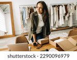 Small photo of Driven by success and passion, this businesswoman prepares a shipping order in her boutique clothing store, determined to launch her online store and become a successful ecommerce entrepreneur.